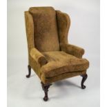 GEORGE III STYLE LARGE WINGED FIRESIDE ARMCHAIR, upholstered and covered in embossed green, blue and