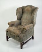 20th CENTURY GEORGE III STYLE WINGED BACK UPHOLSTERED ARMCHAIR with loose cushion seat, covered in