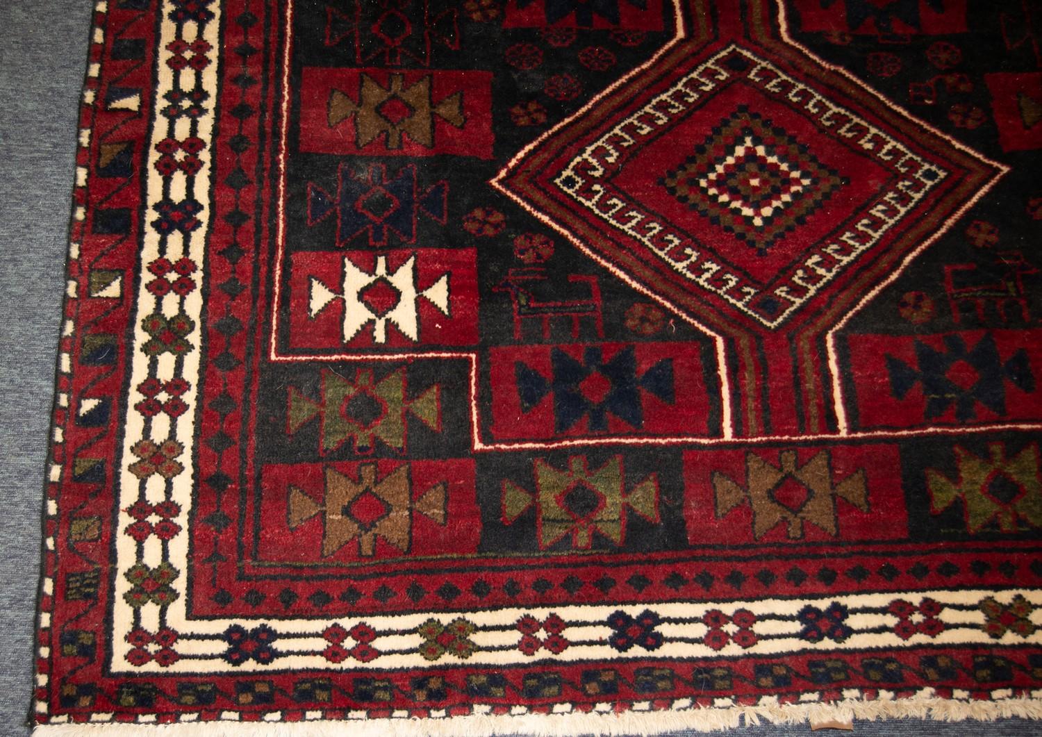 EASTERN CARPET with three diamond pole medallions, on a tile pattern field, the colour predominantly - Image 2 of 3