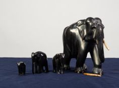 EARLY 20th CENTURY INDIAN LARGE AND HEAVY CARVED EBONY ELEPHANT with ivory tusks, 8in (20.3cm)