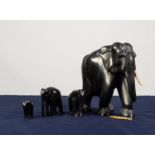 EARLY 20th CENTURY INDIAN LARGE AND HEAVY CARVED EBONY ELEPHANT with ivory tusks, 8in (20.3cm)