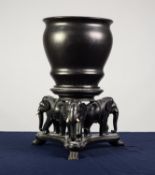 INDIAN WELL-CARVED EBONY CIRCULAR URN STAND supported by three elephants on a triform platform