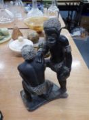 AFRICAN SCULPTURED BLACK STONE GROUP OF TWO MEN, SIGNED UNDER THE BASE 'XYONT AND  B/10' 9 1/4" HIGH