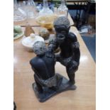 AFRICAN SCULPTURED BLACK STONE GROUP OF TWO MEN, SIGNED UNDER THE BASE 'XYONT AND  B/10' 9 1/4" HIGH