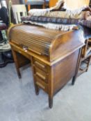 AN OAK SINGLE PEDESTAL ROLL-TOP DESK