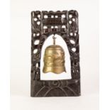 CHINESE HEAVY EMBOSSED BRASS BELL/DINNER GONG, 7 1/4in (18.4cm) high, suspended in a carved and