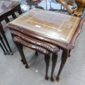 A NEST OF THREE MAHOGANY COFFEE TABLES WITH LEATHER AND GLASS INSET TOPS