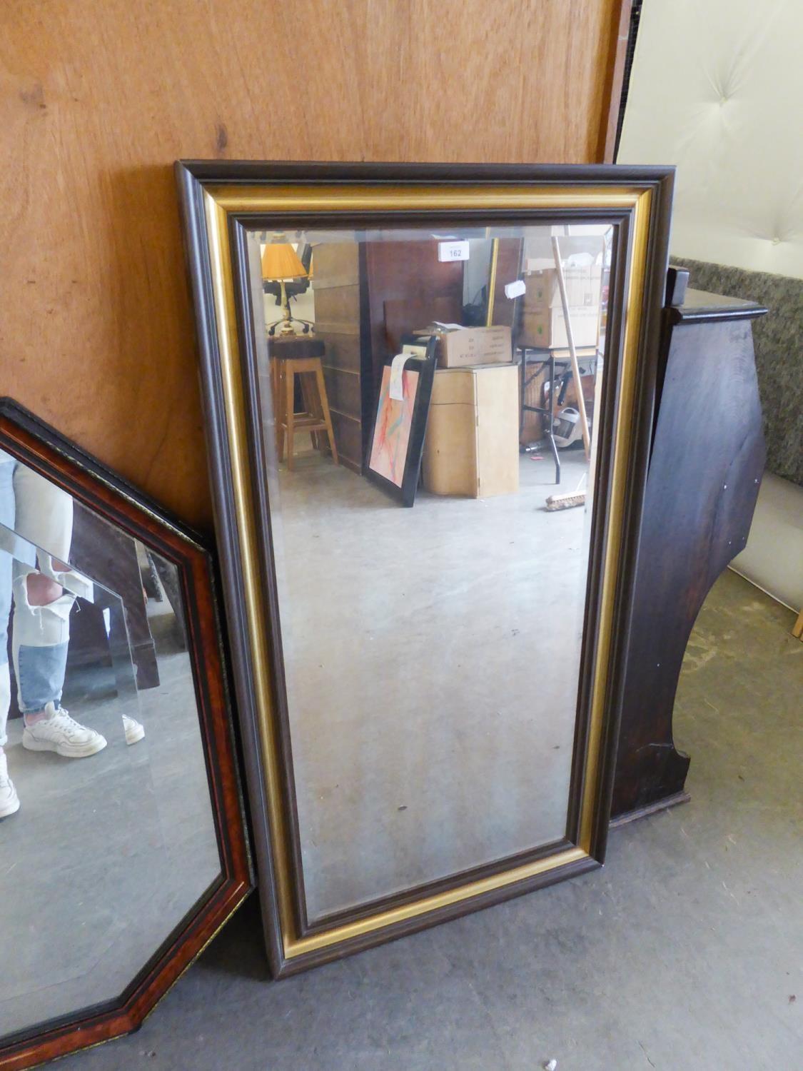 AN OBLONG BEVELLED EDGE WALL MIRROR, IN BROWN AND GILT FRAME, 2?1? X 3?11? OVERALL