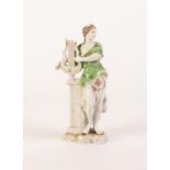 GERMAN PORCELAIN ALLEGORICAL FEMALE FIGURE, modelled standing beside a pedestal and holding a