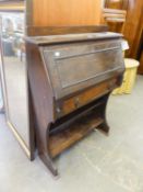 AN OAK BUREAU WITH UPRIGHT FALL-FRONT, TWO OPEN BOOKSHELVES BELOW, 2?6? WIDE