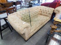 A BUTTON UPHOLSTERED FLORAL FABRIC ROUND-BACKED CHESTERFIELD SETTEE