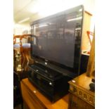 PIONEER 41? FLAT SCREEN TELEVISION, ON AN EBONISED CUPBOARD STAND AND A VIDEO RECORDER