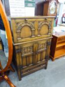 A GOOD QUALITY JACOBEAN STYLE WELL-CARVED MEDIUM OAK COCKTAIL CABINET, THE UPPER SECTION WITH FALL-