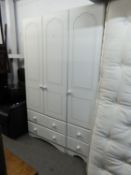 A WHITE FINISH THREE DOOR WARDROBE, WITH TWO ROWS OF THREE SHORT DRAWERS BELOW, WHITE POT KNOB