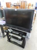 PANASONIC VIERA FLAT SCREEN TELEVISION, 31? WIDE, ON  BLACK GLASS THREE TIER STAND, TOGETHER WITH