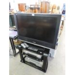 PANASONIC VIERA FLAT SCREEN TELEVISION, 31? WIDE, ON  BLACK GLASS THREE TIER STAND, TOGETHER WITH