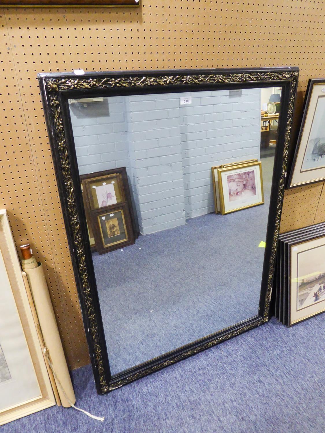 LARGE BEVELLED EDGE WALL MIRROR IN BLACK FRAME HAVING EMBOSSED GILT DECORATION