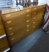 A PAIR OF WOOD EFFECT CHESTS OF FOUR GRADUATED LONG DRAWERS