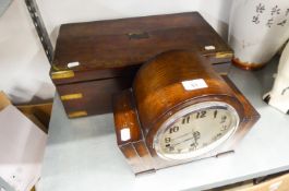 A NINETEENTH CENTURY BRASS BOUND MAHOGANY WRITING SLOPE AND A 1930's OAK MANTEL CLOCK  (2)