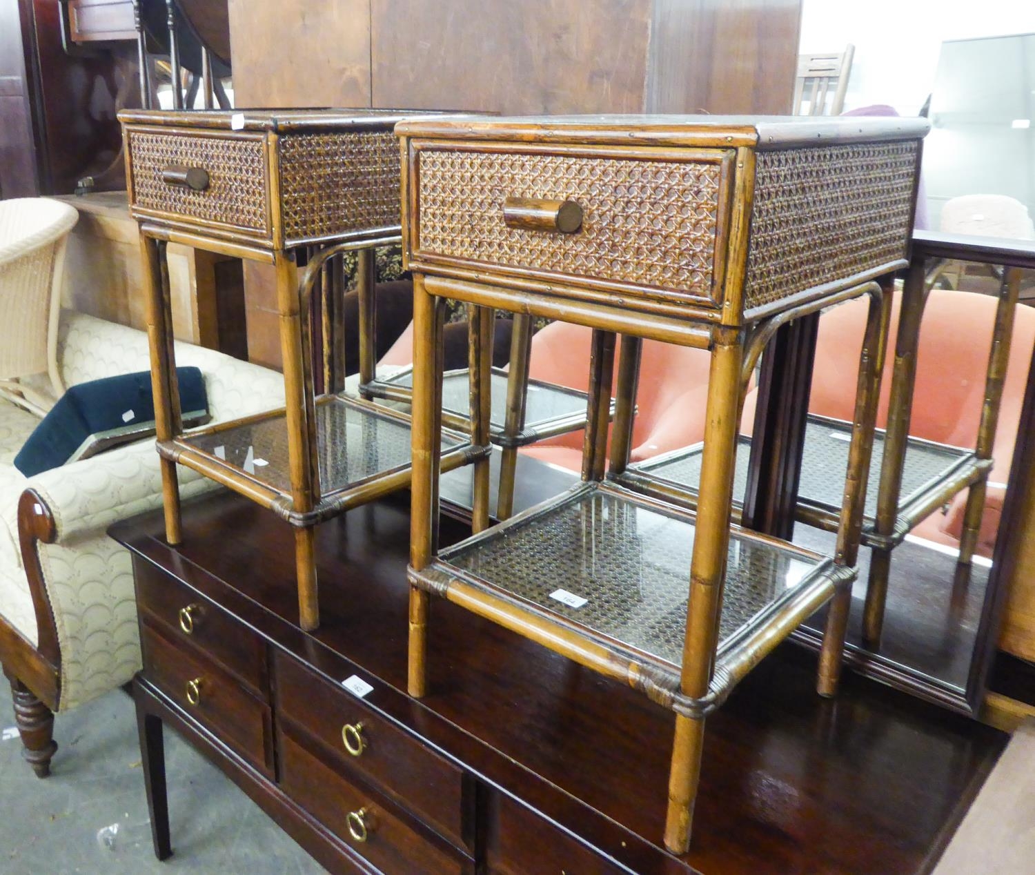 A PAIR OF BAMBOO BEDSIDE TABLES WITH WOVEN CANE PANELS, DRAWER AND UNDER PLATFORM AND INSET GLASS