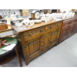 L. MARCUS LTD., LONDON, JACOBEAN STYLE OAK SIDEBOARD WITH ARCH CARVED FRIEZE DRAWERS OVER A LINEN-