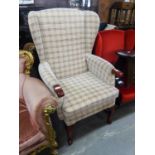 A WINGED FIRESIDE ARMCHAIR, COVERED IN CHECK PATTERN WOVEN FABRIC, ON CABRIOLE FRONT SUPPORTS