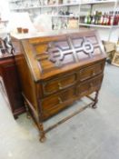 JACOBEAN STYLE OAK BUREAU, WITH MOULDED PANELS TO THE SLOPING FALL-FRONT AND TWO LONG DRAWERS, ON