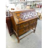 JACOBEAN STYLE OAK BUREAU, WITH MOULDED PANELS TO THE SLOPING FALL-FRONT AND TWO LONG DRAWERS, ON