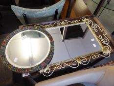 AN OBLONG WALL MIRROR IN WROUGHT IRON FRAME AND A SMALL CIRCULAR MIRROR IN FLORAL EMBOSSED FRAME (2)