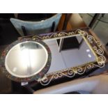 AN OBLONG WALL MIRROR IN WROUGHT IRON FRAME AND A SMALL CIRCULAR MIRROR IN FLORAL EMBOSSED FRAME (2)