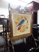 A MAHOGANY FRAMED FLOOR STANDING FIRE SCREEN WITH A PARROT TAPESTRY INSET