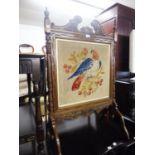 A MAHOGANY FRAMED FLOOR STANDING FIRE SCREEN WITH A PARROT TAPESTRY INSET