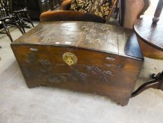 A CARVED WOODEN CAMPHOR CHEST WITH DOME TOP (SPLITS TO TOP)