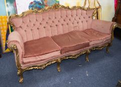 MODERN CARVED GILTWOOD THREE SEATER SETTEE, the ornate scroll carved and pieced show wood frame