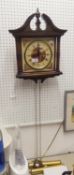 A GERMAN MODERN SIMULATED WOOD CASED WALL CLOCK, WITH BROKEN ARCH PEDIMENT, TWO BRASS WEIGHTS AND