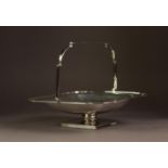 GEORGE V ART DECO SILVER SWING HANDLED PEDESTAL CAKE BASKET BY ALEXANDER CLARK & Co, of square