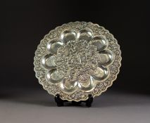 FAR EASTERN SILVER COLOURED METAL CIRCULAR OYSTER DISH, the centre repousse with a village scene