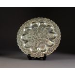 FAR EASTERN SILVER COLOURED METAL CIRCULAR OYSTER DISH, the centre repousse with a village scene