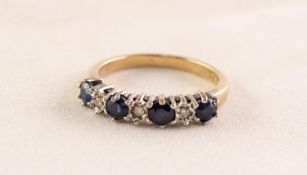 UNMARKED YELLOW GOLD HALF-HOOP RING set with four sapphires and three tiny diamonds,2.4 gms gross