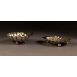 TWO SIMILAR EARLY TWENTIETH CENTURY SILVER SHELL PATTERN BUTTER DISHES both with ball feet,