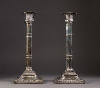 PAIR OF GEORGE III WEIGHTED SILVER CANDLESTICKS, the square bases with gadrooned borders and