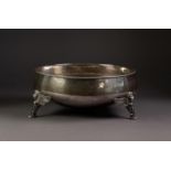 EARLY 20th CENTURY PLANISHED SILVER CIRCULAR BOWL with cabled rim, raised on three winged lion-