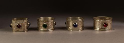SET OF FOUR HEAVY ELECTROPLATED AND COLOURED GLASS SET NAPKIN RINGS, of differing shapes but with