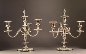 PAIR OF SILVER PLATED ON COPPER FIVE LIGHT, FOUR BRANCH CANDELABRA, each with fancy scroll arms,