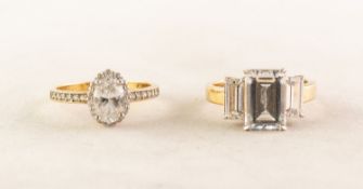 'TRU DIAMONDS' GOLD PLATED RING, set with an emerald cut imitation diamond and two baguette