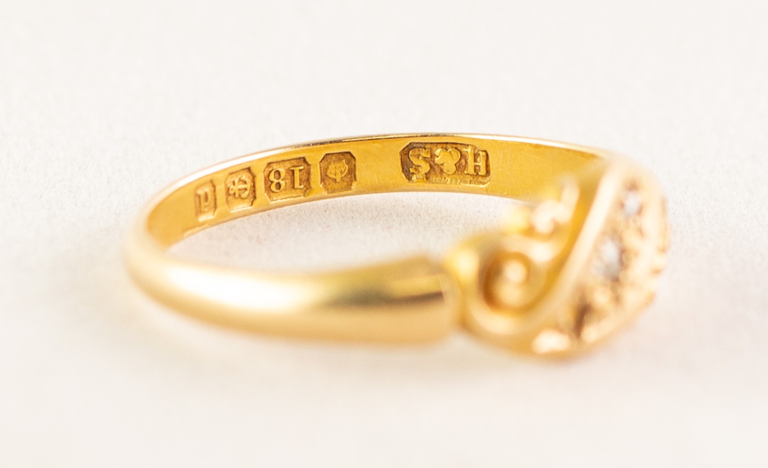 AN EDWARDIAN 18ct GOLD RING, with two tiny rose diamonds in a scroll pattern cross setting (one - Image 3 of 3