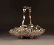 EDWARD VIII PIERCED SILVER SWING HANDLED CAKE BASKET, of shaped oblong form with foliate scroll