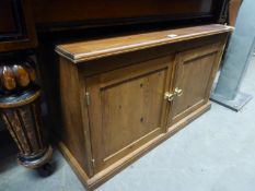 A LOW TWO DOOR PINE CUPBOARD