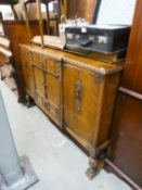 1930's CARVED OAK SIDEBOARD HAVING TWO CENTRAL DRAWERS, CENTRAL CUPBOARD DOORS AND TWO LARGE