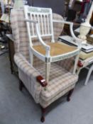 A WINGED FIRESIDE ARMCHAIR, COVERED IN CHECK PATTERN WOVEN FABRIC, ON CABRIOLE FRONT SUPPORTS